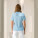 Dámske polo tričko Stella Coaster - stpw977-skyblue_studio_lifestyle_main_back - variant Eg STPW977C2321L